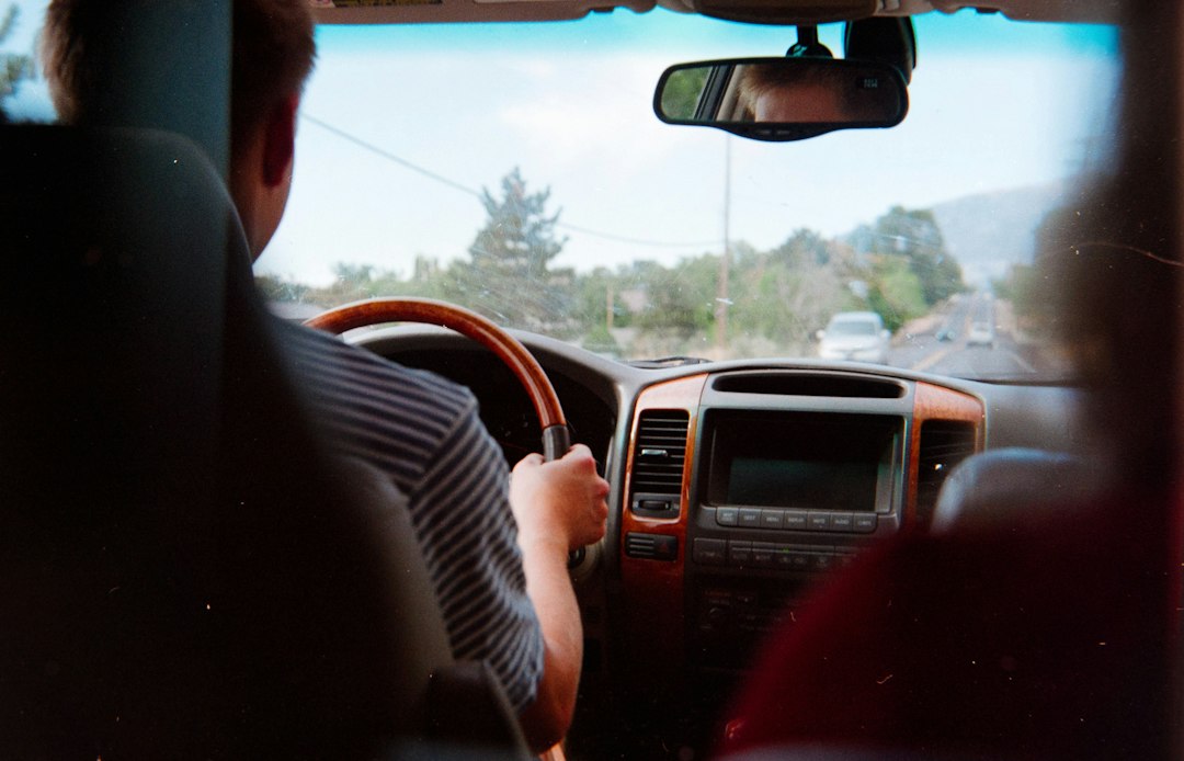 Man driving a car on a sunny day